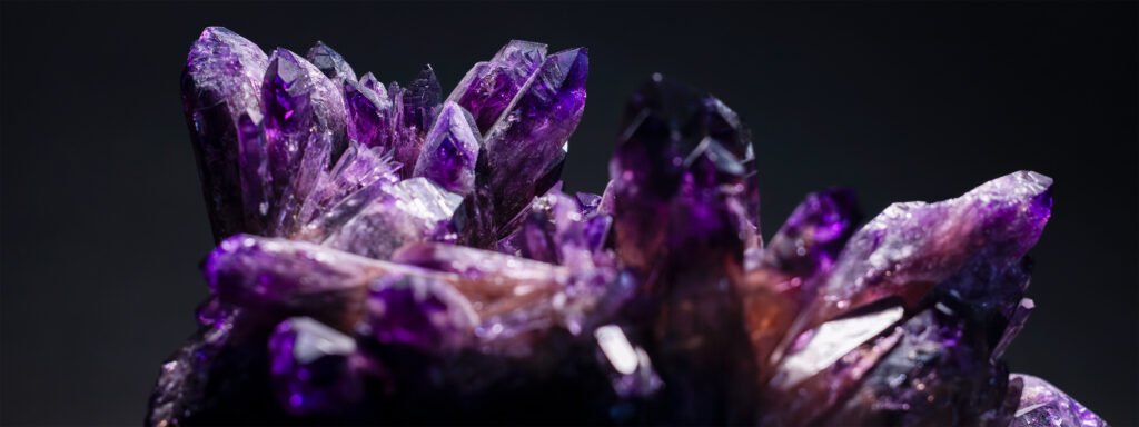 Purple amethyst stone against dark background.