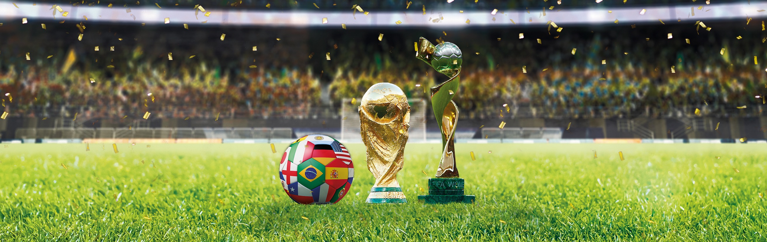 Jalkapallostadionin vihreällä nurmella kaksi kultaista pokaalia ja jalkapallo, jossa on eri maiden lippuja.